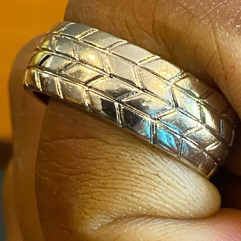 This is a mens sterling silver tire tread wedding band style ring